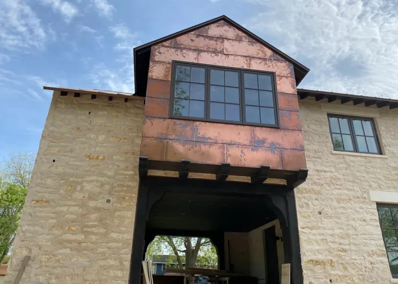 Copper metal panel facade on a stone building for Roof Repair in Oak View